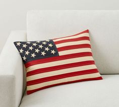 an american flag pillow on a white couch