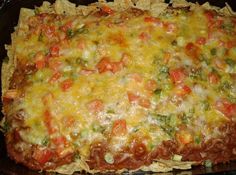 a casserole dish with tortilla shells and vegetables