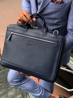 Wales Navy Blue Leather Briefcase is made with 100% leather. This handmade briefcase is especially designed to make you look more stylish and dope. Product: Premium Series Leather Briefcase Color: Navy Blue Width: 35cm Height: 28cm Edge length: 7cm Rear section: 1 back section (A4 size) Key Features: 100% cowhide, unbreakable steel accessories are used in this briefcase and the inner part of briefcase is made with special production lining.  1pcs adjustable Shoulder Strap. Blue Case With Luggage Sleeve For Everyday Use, Blue Cases With Luggage Sleeve For Everyday Use, Blue Business Bag With Luggage Sleeve, Luxury Blue Bag For Work, Luxury Blue Bags For Work, Luxury Blue Work Bag, Classic Blue Rectangular Cases, Classic Blue Rectangular Case, Blue Rectangular Business Cases