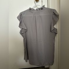 This Shirt Is A Calvin Klein Shirt The Original Price Is 59.00 The Color Is Gray Chic Gray Short Sleeve Tops, Gray Summer Workwear Blouse, Gray Short Sleeve Blouse For Work, Gray Short Sleeve Top For Work, Calvin Klein Short Sleeve Spring Top, Calvin Klein Short Sleeve Top For Spring, Calvin Klein Spring Short Sleeve Top, Gray Casual Ruffled Tops, Casual Gray Ruffle Top