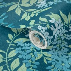 a blue and green flowered wallpaper with leaves on the bottom half of it