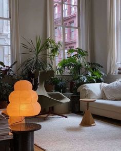 a living room filled with furniture and lots of plants