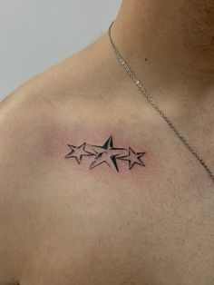 a man's chest with three stars tattoo on his left side ribcage