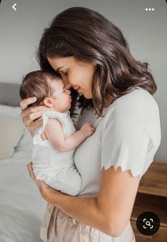 a woman holding a baby in her arms