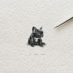 a drawing of a small dog sitting on the ground next to a pen and paper