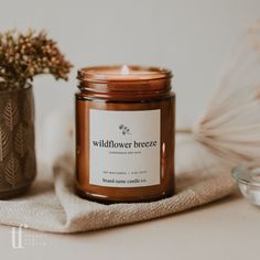 a candle sitting on top of a table next to a vase