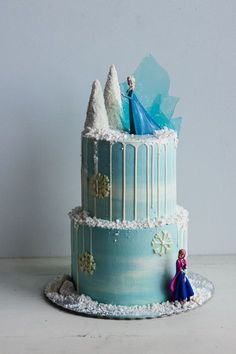 a frozen princess cake with frosting and decorations