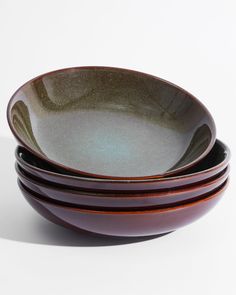 three brown and black bowls stacked on top of each other