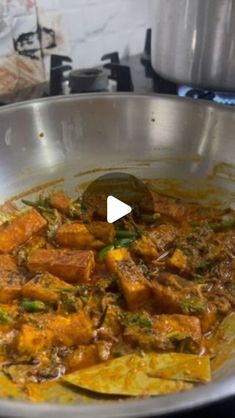 a pan filled with food sitting on top of a stove