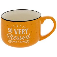 an orange coffee mug with the words, so very messed on it's side