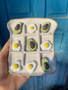 an egg and avocado appetizer is shown in the palm of someone's hand