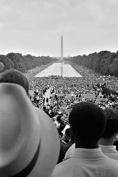 a large group of people standing in front of the washington monument