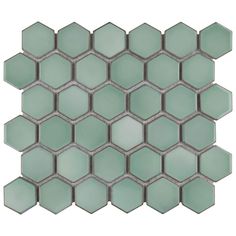 the back side of a glass mosaic tile with hexagonals in light green