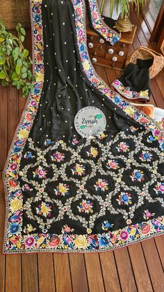 Update! - Zynah covered by LBB - https://lbb.in/bangalore/zynah-designs-handloom-sarees/ This is a beautiful crepe silk saree in black color with colorful Parsi Gara embroidery all over. The saree features pretty and tiny embroidered polka dots twinkling all over the body of the saree. The border is richly decorated with colorful Parsi Gara embroidery where the flowers are blooming in multicolors with leaves and birds, this continues to the pallu edges too. The pallu has rich floral jaal with floral motifs. The edges of the saree is beautified with contrast color cord piping. The Parsi Gara embroidery is the stunning beauty of the saree. Zynah's latest introduction and original design on Pure Crepe silk is an amalgamation of Indian embroidery with a Persian heritage and a Chinese origin. R Luxury Saree With Pallu For Navratri, Luxury Saree With Intricate Embroidery For Navratri, Luxury Resham Embroidered Saree For Navratri, Luxury Saree With Border For Navratri, Luxury Handwork Saree For Navratri, Luxury Silk Thread Navratri Saree, Luxury Silk Thread Saree For Navratri, Luxury Navratri Saree With Border, Luxury Saree With Woven Motifs For Navratri