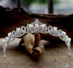 Adorned with iridescent pearls and intricately faceted clear rhinestones that work their way across the band in a swirly pattern, this delicate tiara can complete the most sophisticated of bridal looks. Cast in lightweight alloy and rhodium plated for a flawless finish, the headband measures 1.25" at the tallest point (approx. 3.2cm) and 5.5" across (approx. 14cm). Two small loops at each end make it easy to attach to your hair with bobby pins. Its incredible sparkle coordinates with any color w Real Tiaras, Pearl Tiara Wedding, Hair Accessories Pearl, Rhinestone Tiara, Iridescent Pearl, Princess Tiara, Rhinestone Bridal