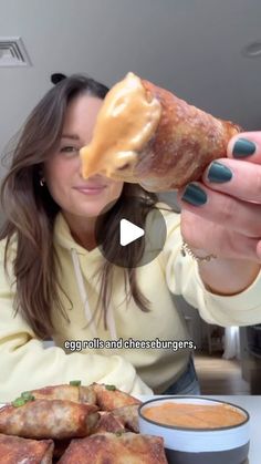 a woman is eating some food at the table