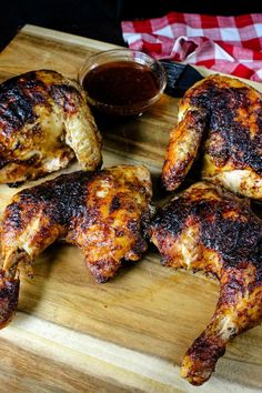 grilled chicken wings on a cutting board with dipping sauce