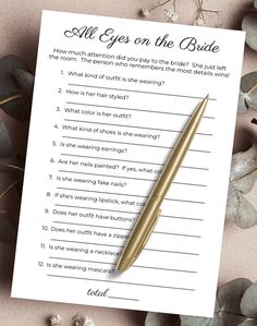 a pen sitting on top of a paper next to some flowers and leaves with the words all eyes on the bride written in it