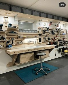 a room filled with lots of wooden shelves and tools on top of each shelf in front of a computer desk