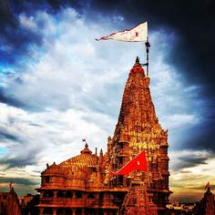 a tall tower with a flag flying from it's top on a cloudy day