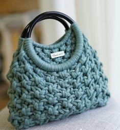 a crocheted purse sitting on top of a couch