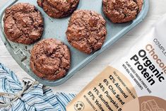 chocolate cookies in a muffin tin next to a bag of flour