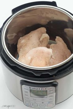 two pieces of chicken are in an electric pressure cooker