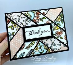 a hand holding up a thank you card with flowers and leaves on the inside of it