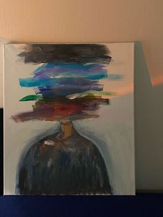 a painting with multiple colors on it and a person's head in the background