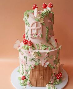 a pink cake decorated with flowers and leaves