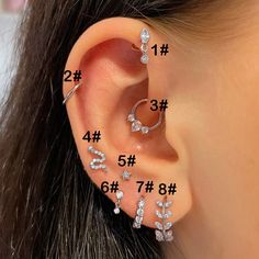 an ear with three different types of piercings on the top and bottom of it