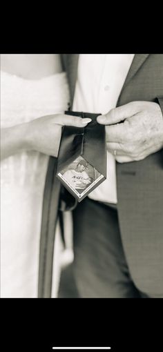 the bride and groom are holding their wedding rings