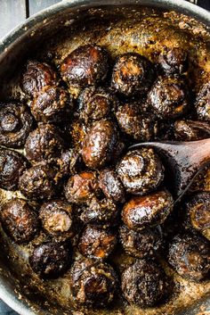 a pan filled with meatballs on top of a wooden table