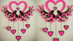 two pictures of pink and black hearts hanging from tree branches with birds on branch in the middle