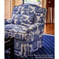 a blue and white chair sitting on top of a rug