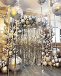 a room filled with lots of silver balloons