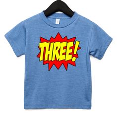 a blue t - shirt with the word two printed in yellow and red on it