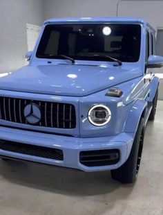 a blue mercedes truck parked in a garage