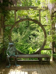 a person sitting on a bench in the middle of a garden