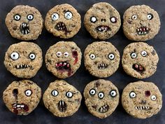 chocolate chip cookies with eyes and mouths are arranged on a black surface