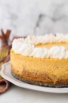 a cheesecake topped with whipped cream on a plate