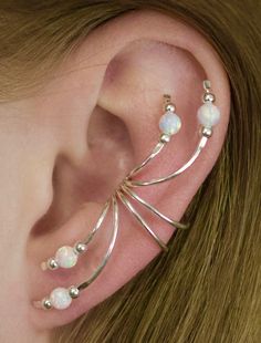 This a beautifully delicate ear cuff that is bound to make a statement with a small splash of color with either a Blue or White Opal. This Ear Cuff decorates the ear from top to bottom. It hugs the ear in the center of the ear comfortably and securely without piercing and decorates the entire ear. We use only the highest quality materials 14K Gold Filled and Sterling Silver. This item will ship in a Gift Box with easy fitting instructions. Ready for gift giving! Gold Ear Crawlers, Minimalist Ear Cuff, Gold Ear Climbers, Silver Ear Climbers, Ear Crawler, Pierced Ear, Ear Climber, Wrap Earrings, Gold Ear Cuff