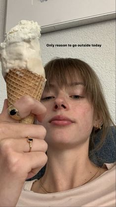 a woman holding an ice cream cone in her hand