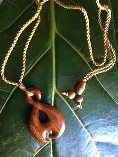 "KOA WOOD Tribal Design Pendant with Adjustable Cotton Cord Necklace Pendant: Approx. 1\" x 1.5\" Cord Necklace: Approx. 28\" long (Adjustable) This is a beautifully hand-crafted pendant made of natural koa wood in a traditional Polynesian spiral design. Brown braided cotton necklace has an adjustable sliding knot to adjust the necklace into any desirable length. Wear it close to your neck as a choker or longer as a pendant/necklace. Keep in mind the shade of pendant might varies cause of natura Adjustable Artisan Natural Wood Necklace, Adjustable Carved Natural Color Necklaces, Adjustable Natural Color Carved Necklaces, Natural Carved Adjustable Jewelry, Natural Color Carved Adjustable Jewelry, Adjustable Natural Wood Pendant Jewelry, Adjustable Traditional Natural Wood Jewelry, Adjustable Natural Wood Traditional Jewelry, Adjustable Carved Brown Necklace