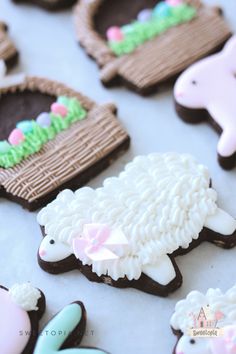 decorated cookies are arranged in the shape of sheeps and lambs on a table