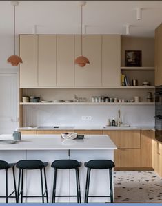 an image of a kitchen setting with bar stools in the foreground and cabinets in the background