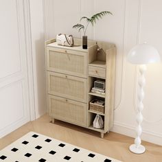 an empty room with a lamp, dresser and rug on the floor in front of it