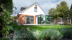 a modern house with an extension to the rear yard and garden area is seen in this image