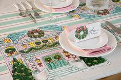 a table set for christmas with place settings and napkins on top of the plates