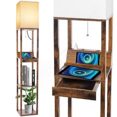 a wooden table with a laptop on it and a lamp next to it in the shape of a bookcase